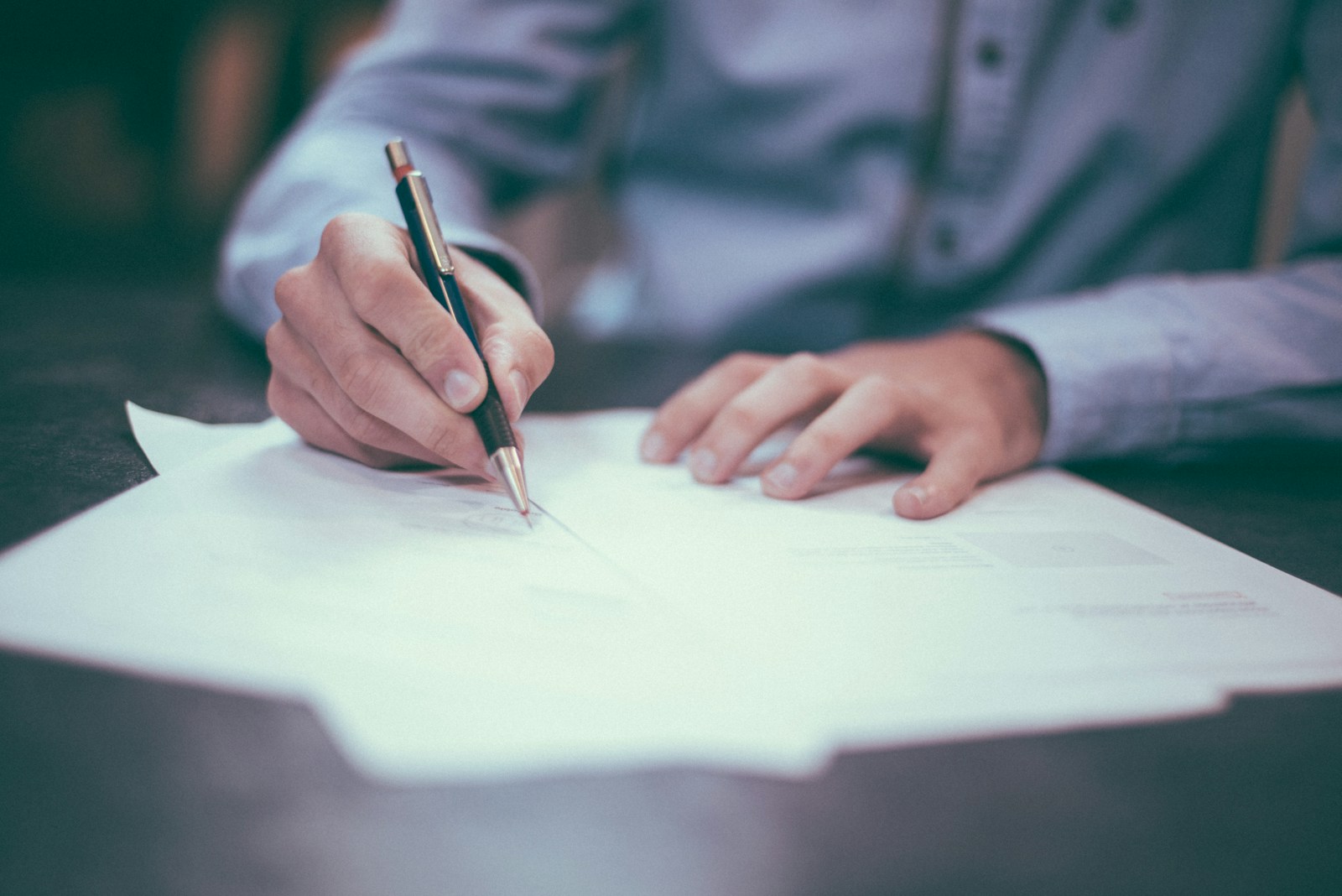 A professional carefully reviewing documents